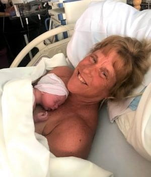 Barb on hospital bed with newly born Jack