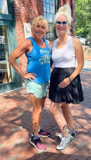 Barb is smiling standing next to her friend, Susan.