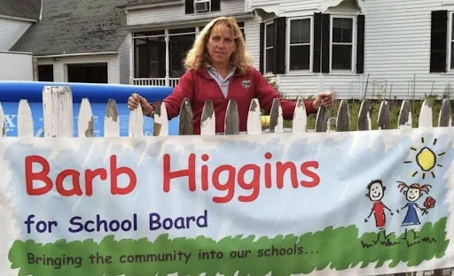 Barb standing with sign running for school board in 2011