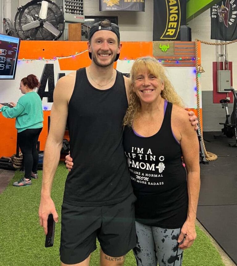 tyler and barb standing together at gym