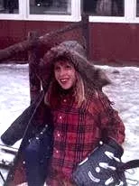 young barb after skiing, smiling at camera with winter jacket half on