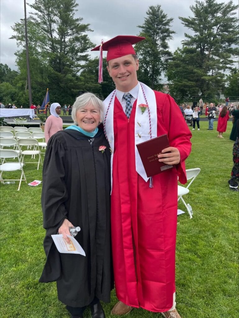Katleen and Sam post at Concord High School graduation celebrate at outdoor commencement ceremony.