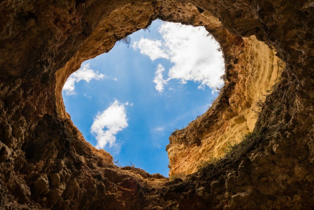 Sky view from rocky cave opening